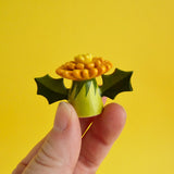 A small stylized dandelion figurine